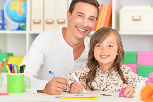 Father and daughter painting at home Royalty Free Stock Images