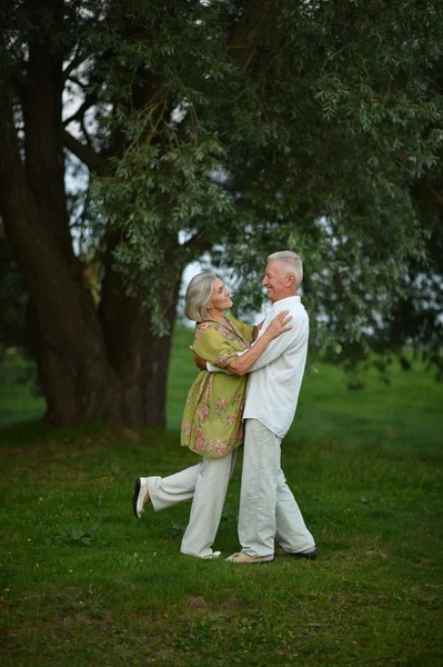 Mature couple in spring park — Stock Photo, Image