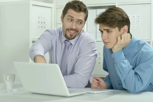 Two businessmen working on a laptop — Stock Photo, Image