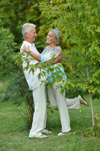 Mature couple in spring park — Stock Photo, Image