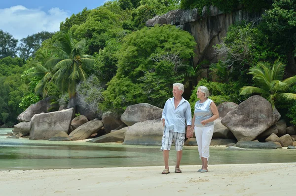 Elderly couple rest at tropical beach — Stock Photo, Image