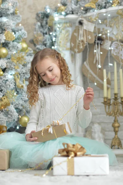 圣诞时带着礼物坐在一起的快乐女孩的画像 — 图库照片