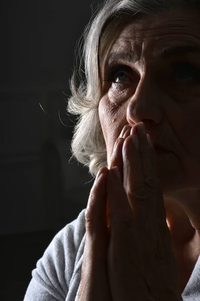Portrait of beautiful  senior woman praying