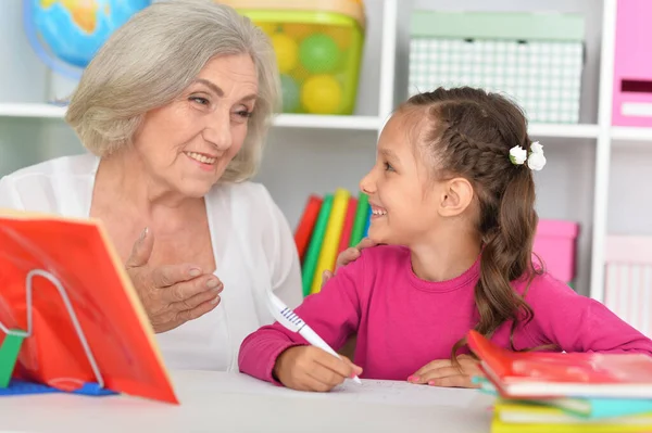 Porträt Eines Kleinen Mädchens Das Mit Seiner Großmutter Hause Hausaufgaben — Stockfoto