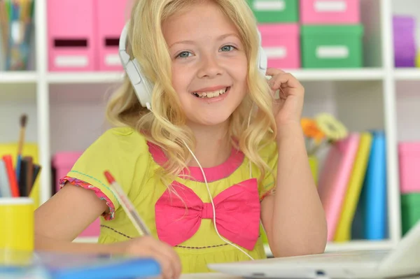 Schattig Meisje Hoofdtelefoon Ding Met Laptop Zitten Aan Bureau — Stockfoto