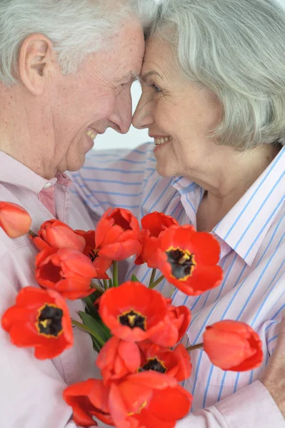 Happy Senior Couple Home Flowers Stock Image