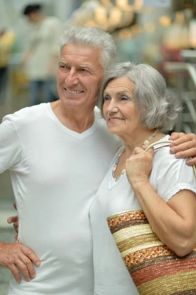 Beautiful elderly couple in shopping mall — Stock Photo, Image