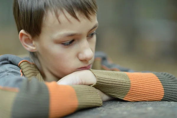 Little sad boy in a warm sweater — Stock Photo, Image