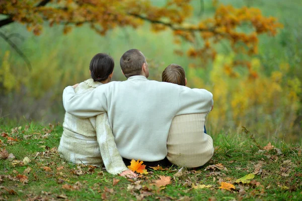 一家人坐在秋天的公园 — 图库照片