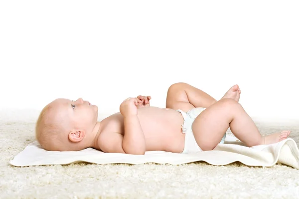 Little boy in pampers lying on his back — Stock Photo, Image