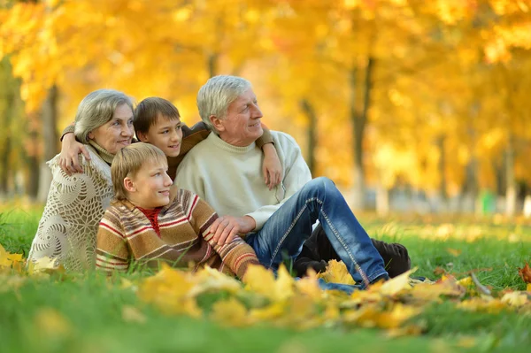 Grandparents and grandchildren in autumn park — Stock Photo, Image