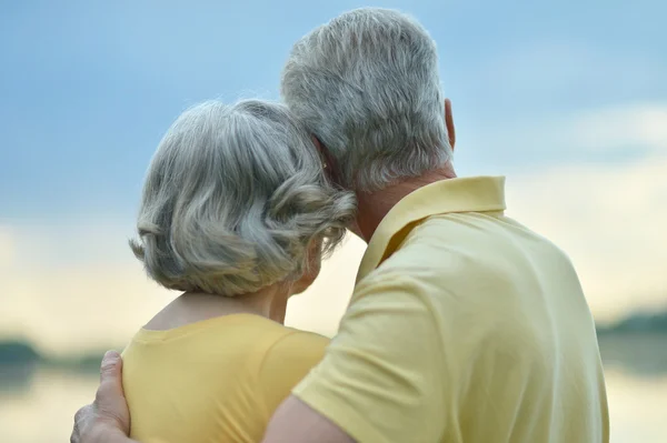 Couple âgé assis près du lac — Photo