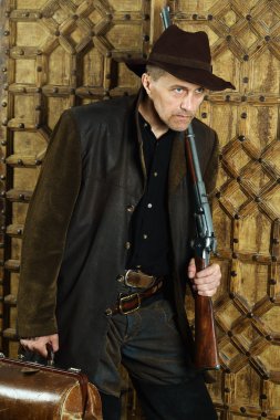 Bandit with gun in the wild west clipart