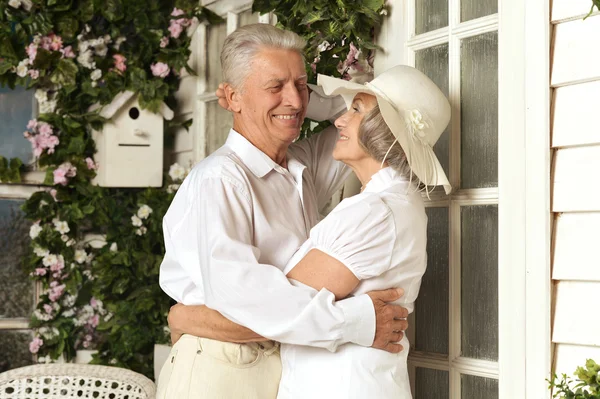 Elderly couple on wooden porch — Stock Photo, Image