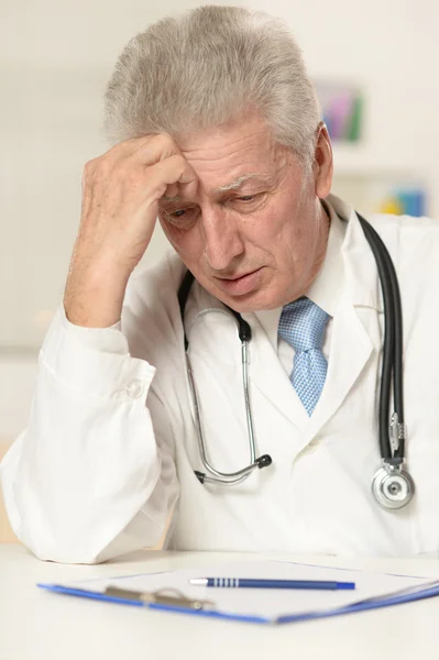 Médico de edad avanzada en la mesa — Foto de Stock