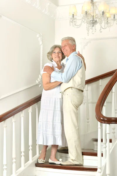 Beautiful elderly couple on stairs — Stock Photo, Image