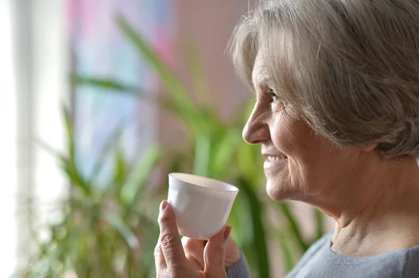 Senior woman with cup — Stock Photo, Image