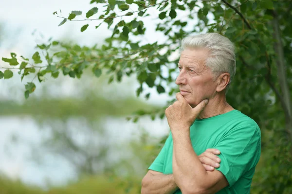 Serious senior man thinking in park — Stock Photo, Image