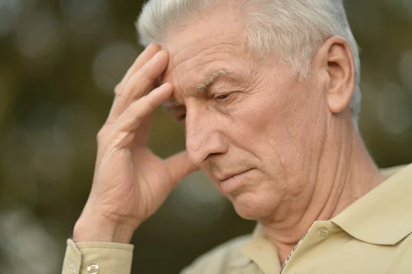 Serious senior man thinking in park — Stock Photo, Image