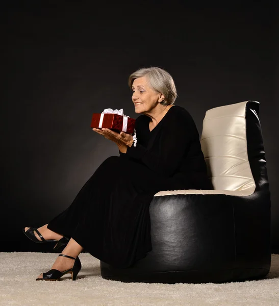 Kvinna sitter med gåva — Stockfoto