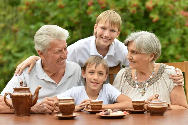 Happy family drinking tea at table — Stock Photo, Image