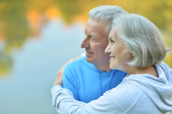 Romantic mature couple sitting in park — Stock Photo, Image