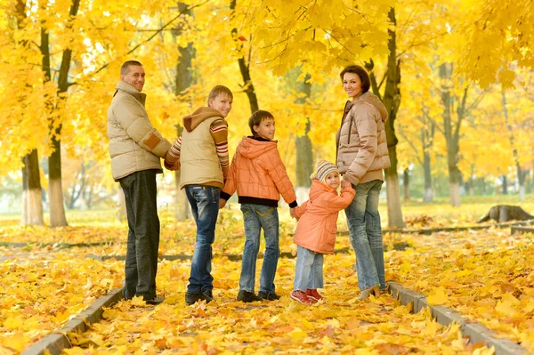 Happy family in autumn forest — Stock Photo, Image