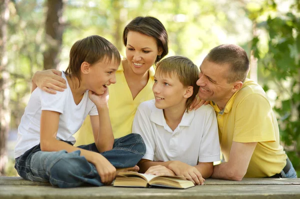 Family reading outdoors