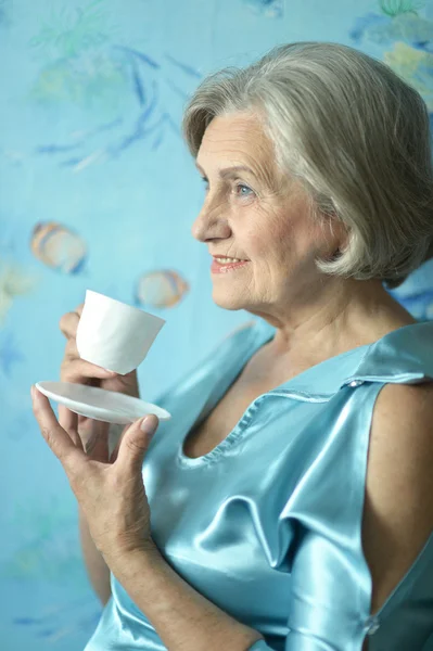 Retired woman drinking tea — Stock Photo, Image