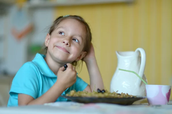 Cute little girl eating berries Royalty Free Stock Photos