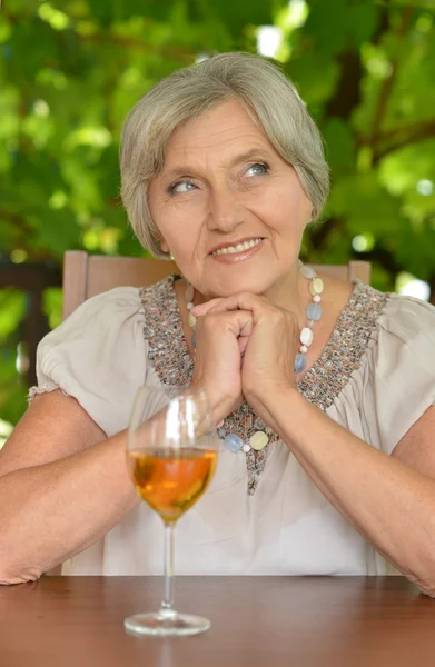 Old woman drinking wine — Stock Photo, Image