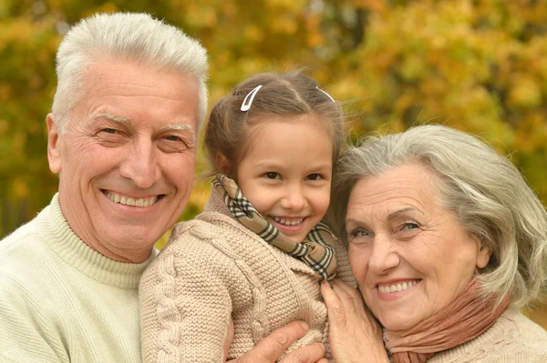 Grandparents with girl in forest — Stock Photo, Image