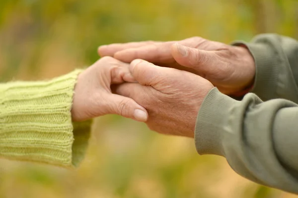 Elderly couple holding hands — Stock Photo, Image