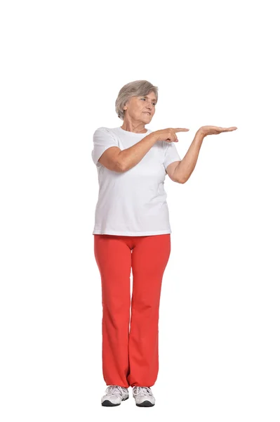 Senior woman in sportswear  pointing — Stock Photo, Image