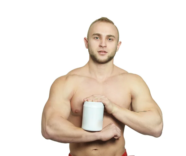 Bodybuilder håller burken med protein — Stockfoto
