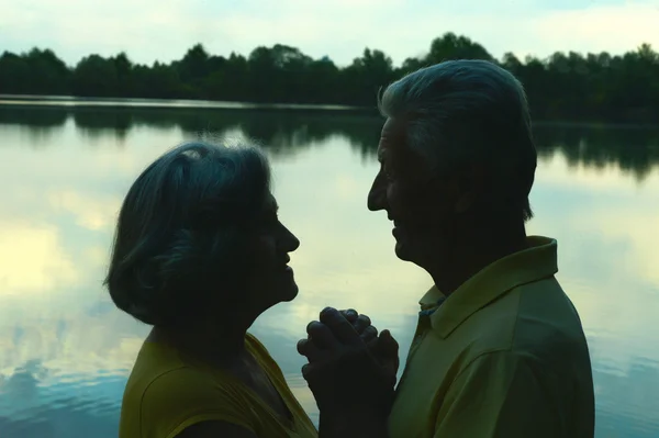 Elderly couple at night river — Stock Photo, Image