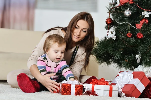 Mor med pojke nära julgran Stockfoto