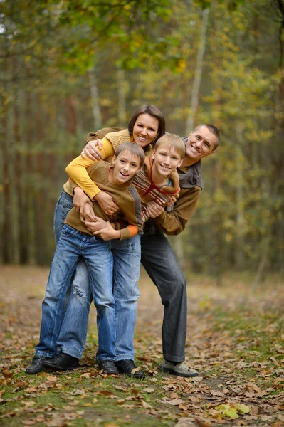 Family relaxing in autumn park — Stock Photo, Image