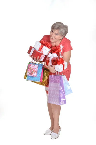 Elderly woman holding gifts — Stock Photo, Image