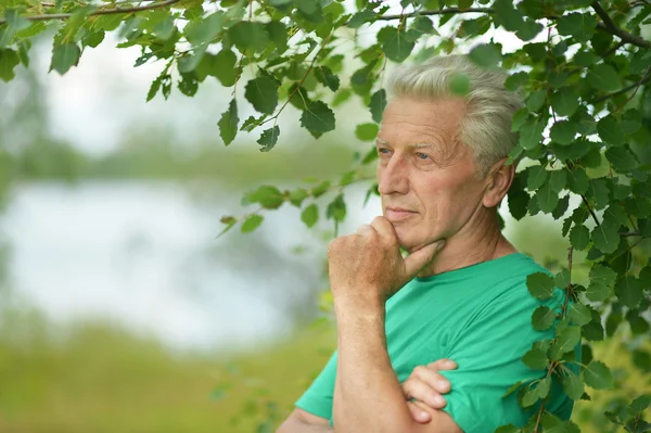 Portrait of old man on nature — Stock Photo, Image