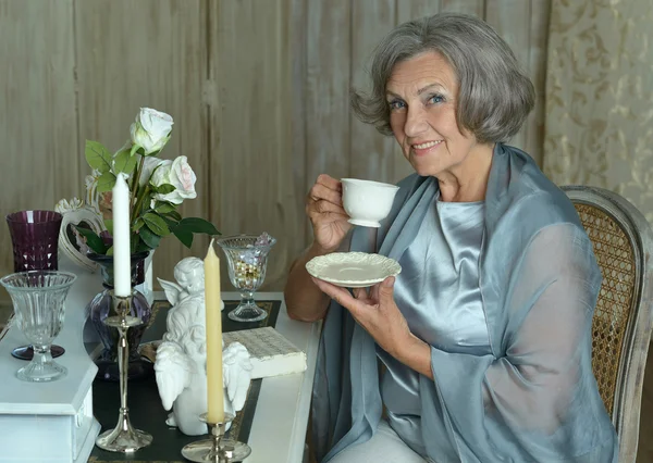 Elderly woman drinking tea — Stock Photo, Image