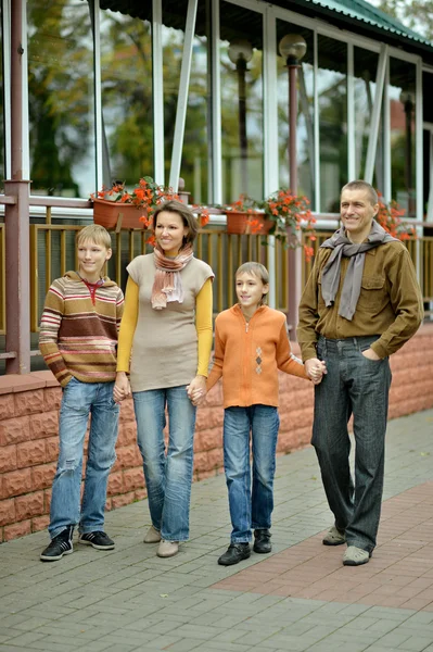 Family relaxing in autumn park — Stock Photo, Image