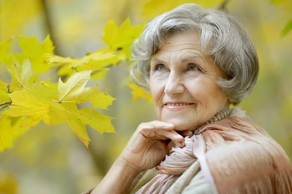 Donna anziana nel parco autunnale — Foto Stock