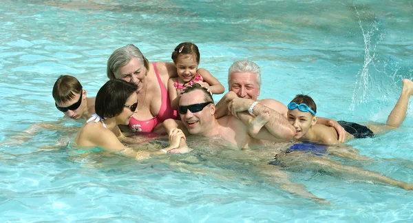 Familie ontspannen in het zwembad — Stockfoto