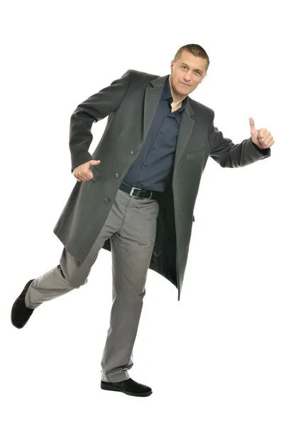 Man in coat with thumb up — Stock Photo, Image