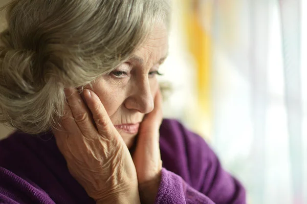 Sad aged woman at home — Stock Photo, Image