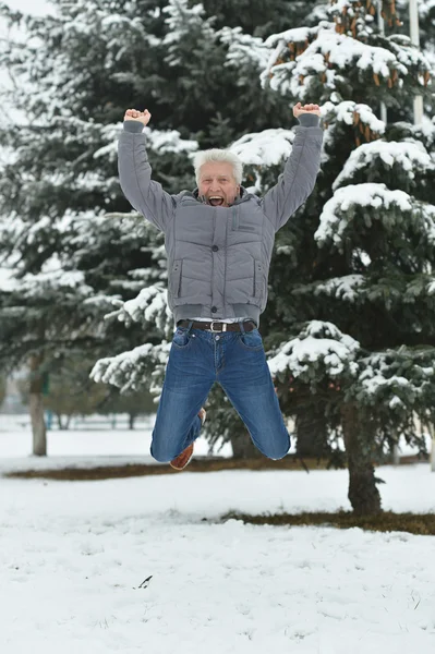 Senior man jump in winter — Stock Photo, Image