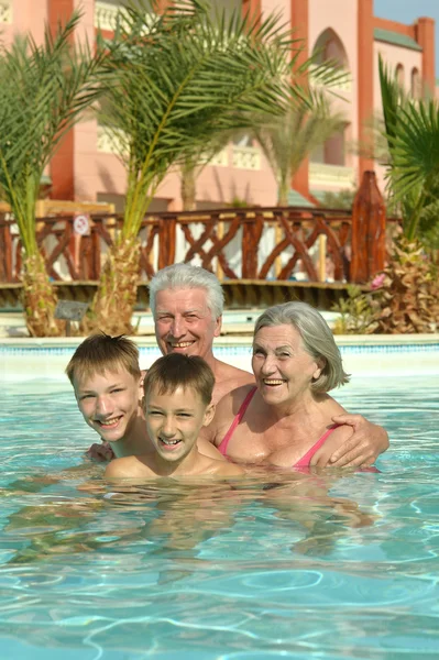 Großeltern mit Enkeln im Pool — Stockfoto