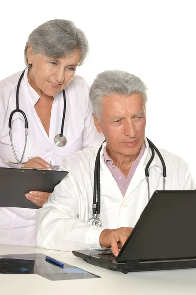 Doctors in white coats with laptop — Stock Photo, Image