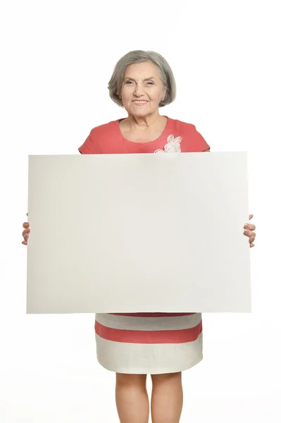 Senior woman with white poster — Stock Photo, Image